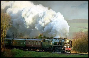 Railways build - a steam train chugs across the countryside.